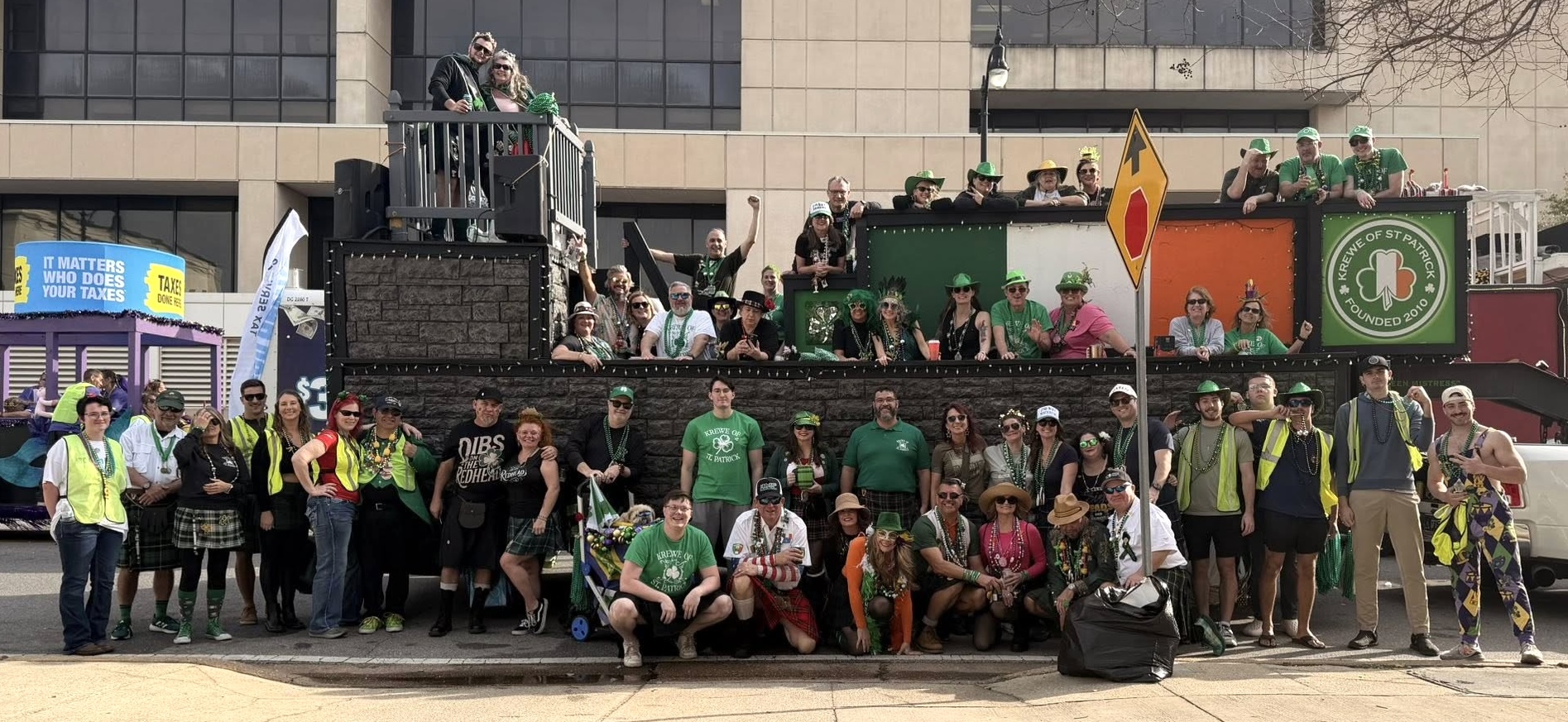 Krewe of St. Patrick members gathered in front of the parade float