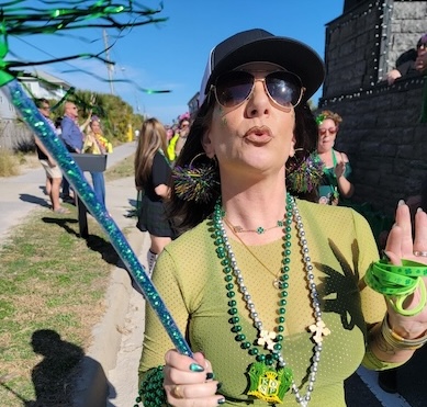 Member parading in green kilt and beads